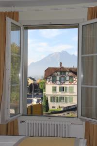 a window with a view of a building at Gasthaus zum Kreuz in Lucerne
