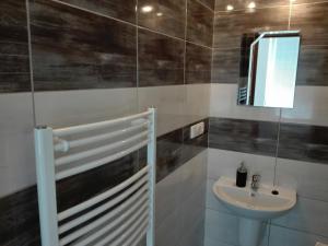 a bathroom with a sink and a mirror at Penzion U Hyklů in Veřovice +49 photos