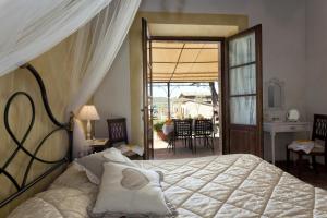 a bedroom with a bed and a door to a patio at Agriturismo San Marcello in Castiglione dʼOrcia