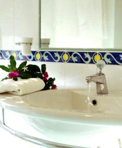 a bathroom sink with a towel and a faucet at Hotel Dino in San Benedetto del Tronto