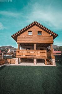 a large wooden cabin with a large deck at Apartmány Štefanova in Terchová