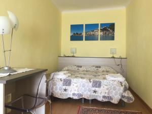a bedroom with a bed and two pictures on the wall at Casa Camilla in Montemarcello