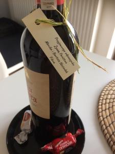 a bottle of wine on a table with a label on it at Apartament Fibra Mocca in Rybnik
