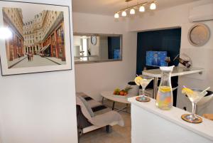 a living room with a table with a picture on the wall at Apartment Piazzeta De Luxe in Split
