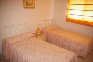 A bed or beds in a room at Villamar Orange Costa