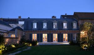 a large house with a blue roof at Notarishuis Beveren B&B in Beveren