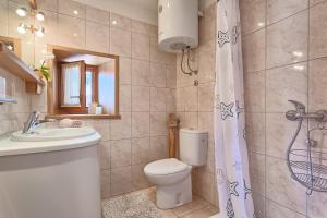 a bathroom with a toilet and a sink and a shower at Studio Mia in Premantura +29 photos