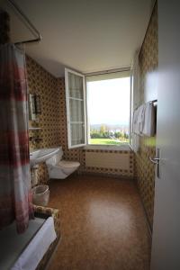 a bathroom with a window and a sink and a toilet at Gasthaus zum Kreuz in Luzern