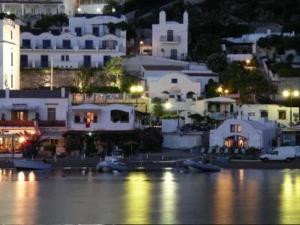 a city with white buildings and a harbor at night at Appartamenti Helvetia in Peschici +21 photos