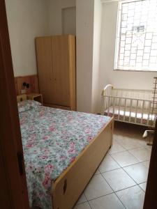 a bedroom with a bed and a crib at Appartamenti Helvetia in Peschici