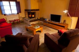 a living room with two couches and a fireplace at Casa Rural Etxegorri in Orozko