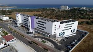an aerial view of a large white building with a street at Amethyst Napa Hotel & Spa in Ayia Napa