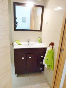 a bathroom with a sink and a mirror at tarragonaapartments arrabassada beach in Tarragona