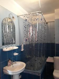 a bathroom with a tub and a sink and a shower at Pensiunea Sydney in Timişoara