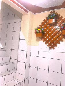 a bathroom with two potted plants on a wall at Hotel Fortaleza III Manaus in Manaus