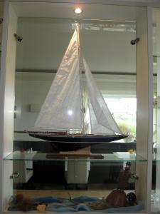 a glass shelf with a sail boat on it at Miramar in Helgoland