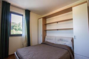 a small bedroom with a bed and a window at Antica Pieve in Filattiera