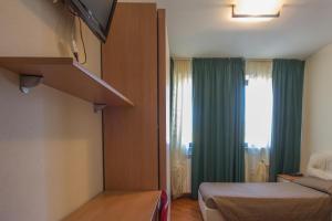 a hotel room with a bed and a window at Antica Pieve in Filattiera