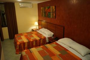 Postel nebo postele na pokoji v ubytování Hotel Chicama