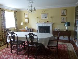 a dining room with a table and chairs and a fireplace at The Gin Gan in Hexham