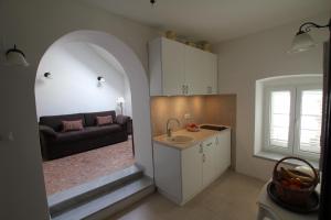 a kitchen with a sink and a couch in a room at Antunini II in Dubrovnik