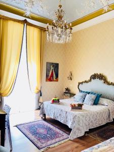 a bedroom with a bed and a chandelier at Dimora Umberto in Catania