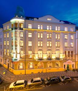 a large building with a large clock on the side of it at Theatrino Hotel in Prague