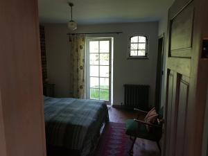 a bedroom with a bed and a window at Silna Nowa 2 in Pszczew