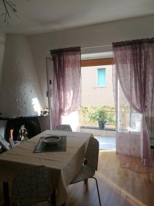 a living room with a table and a large window at Costaguta Apartment in Rapallo