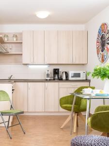 a kitchen with wooden cabinets and a table and chairs at Zelný trh 31 in Brno