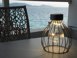 a lamp on a table with a view of the ocean at A unique seaside view!!! in Rhodes Town