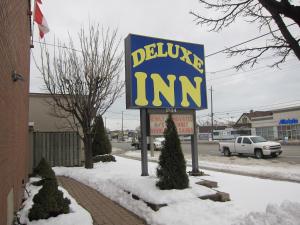 a sign for a deluca inn in the snow at Deluxe Inn in Toronto