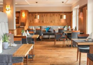 a kitchen filled with furniture and a table at Wellnesshotel Riedlberg in Drachselsried