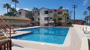 a swimming pool in front of a building at villa serena 4 Beds, 2 Bath in Rosarito