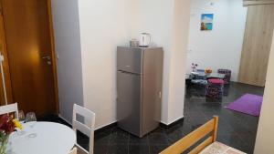 eine Küche mit Tisch und Kühlschrank in der Unterkunft Room Tereza in Zadar
