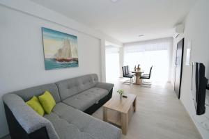 a living room with a couch and a sail boat on the wall at Villa Martina in Ika
