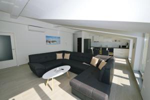 a living room with a couch and a table at Villa Martina in Ika