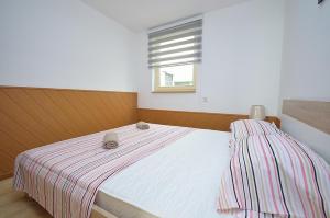 Postel nebo postele na pokoji v ubytování Apartmani Ana