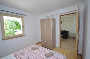 Postel nebo postele na pokoji v ubytování Apartmani Ana