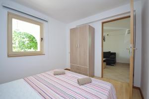 Postel nebo postele na pokoji v ubytování Apartmani Ana