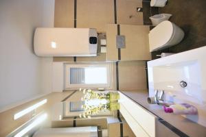 a bathroom with a counter with a sink and a toilet at Villa Martina in Ika +62 photos