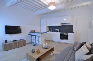 a white living room with a couch and a table at Superb one-bedroom apartment - StayInAntibes- Picasso 1 in Antibes