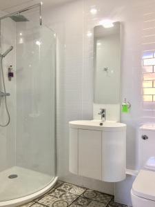 a white bathroom with a sink and a shower at Edinburgh37 in Edinburgh +71 photos
