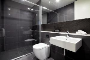 a bathroom with a white toilet and a sink at 381 Cremorne in Melbourne