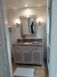 a bathroom with a mirror and a sink at Candelaria House Boutique in Bogotá