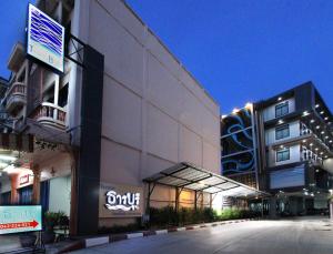 a building with a sign on the side of it at Thanburi Hotel in Udon Thani