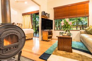 a living room with a wood stove at Lillypilly's Cottages & Day Spa in Maleny