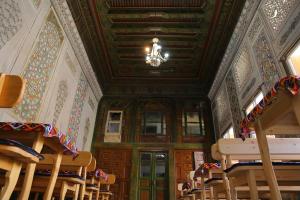 a church with a chandelier in a room with wooden ceilings at Rabat Boutique in Samarkand