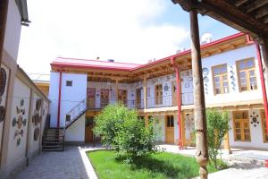 an old building with a staircase in a courtyard at Rabat Boutique in Samarkand