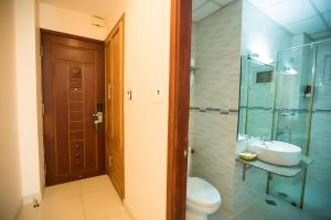 a bathroom with a sink and a toilet and a shower at Ipeace Hotel - Bùi Viện Walking Street in Ho Chi Minh City